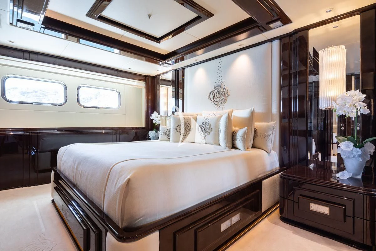 a bedroom with a large bed aboard ILLUSION V Yacht for Charter