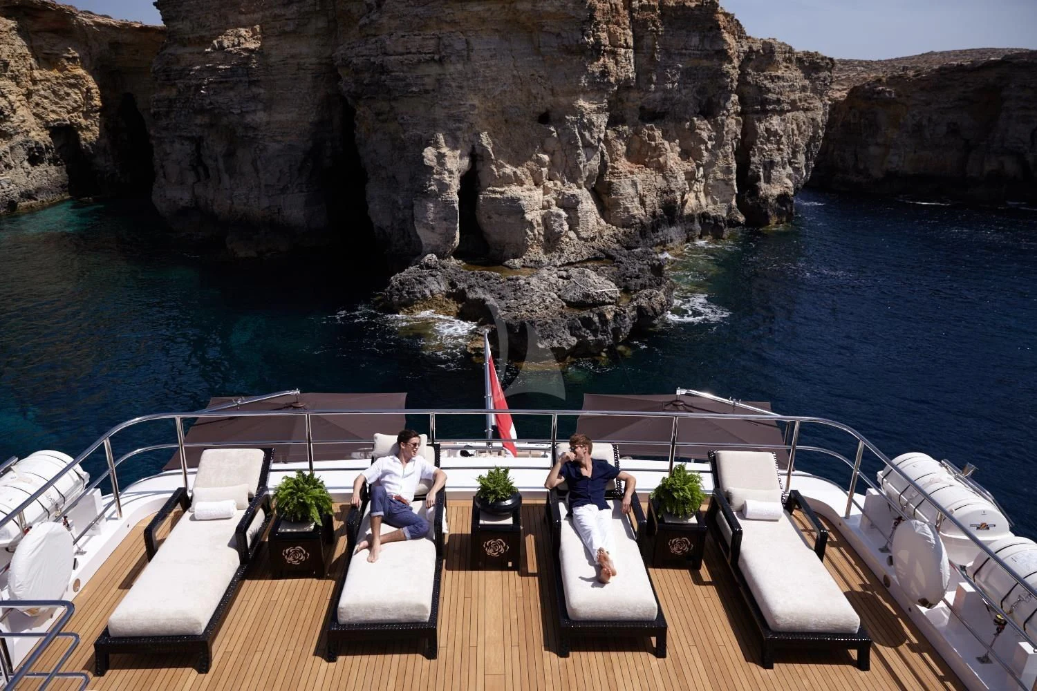 a couple sitting on a boat aboard ILLUSION V Yacht for Charter