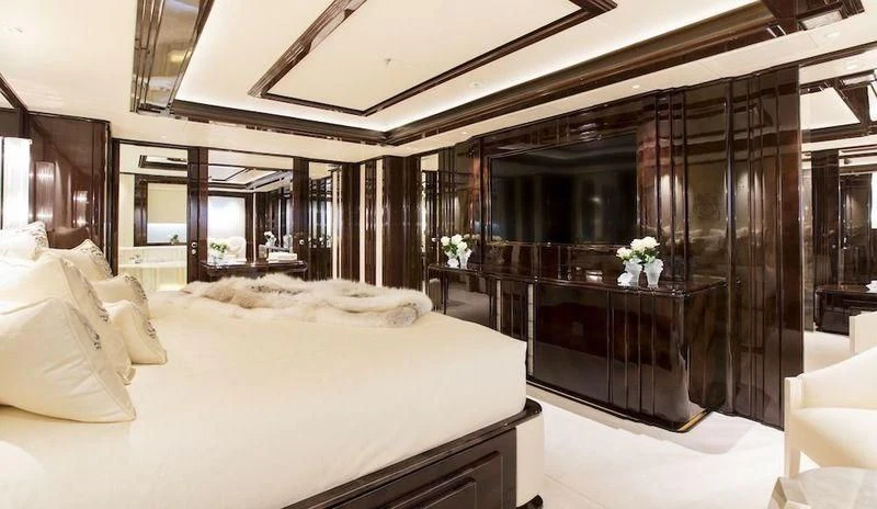 a room with a bed and a table aboard ILLUSION V Yacht for Charter