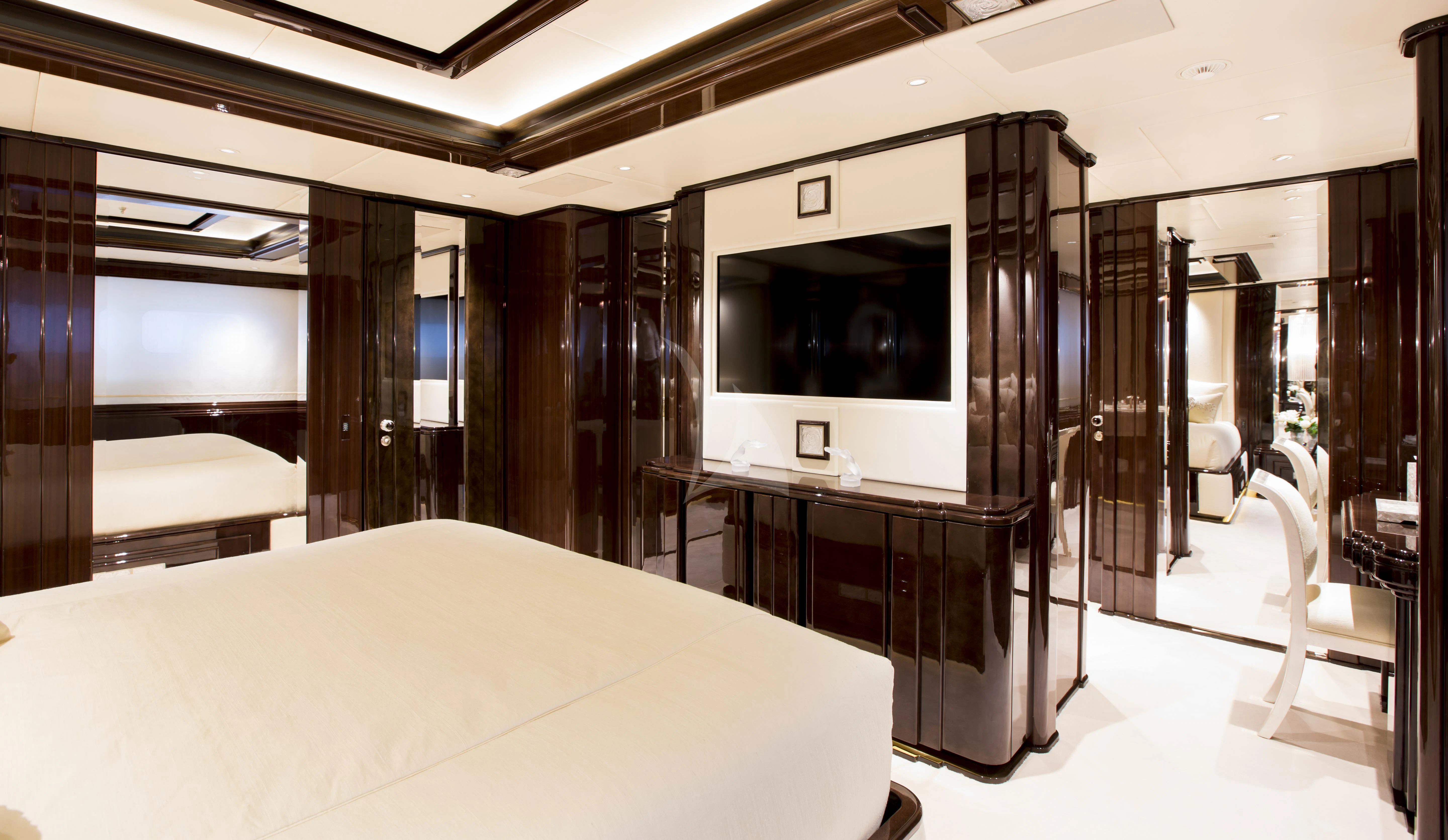 a room with a bed and a desk aboard ILLUSION V Yacht for Charter