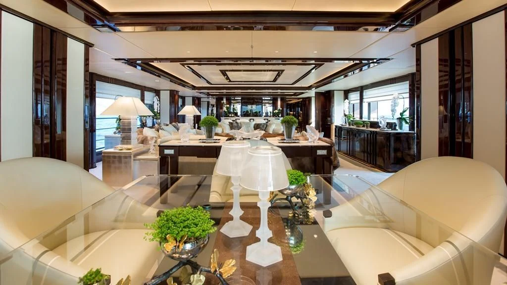 a large room with a table and chairs aboard ILLUSION V Yacht for Charter