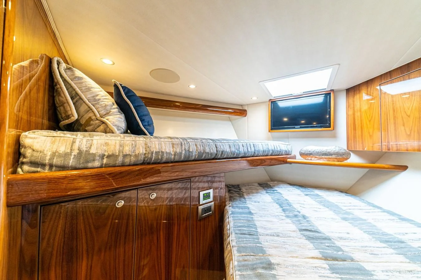a room with a bed and a television aboard MANA Yacht for Sale