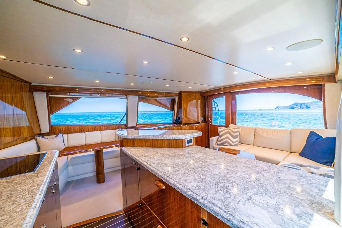 a room with a bed and a large window aboard MANA Yacht for Sale