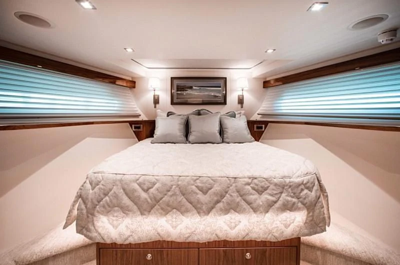 a bed with a white comforter aboard MANA Yacht for Sale
