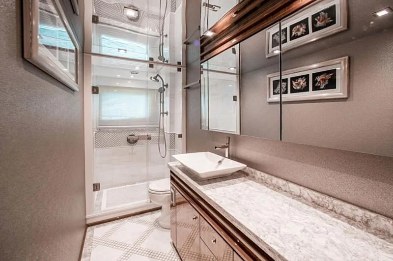 a bathroom with a large mirror aboard MANA Yacht for Sale