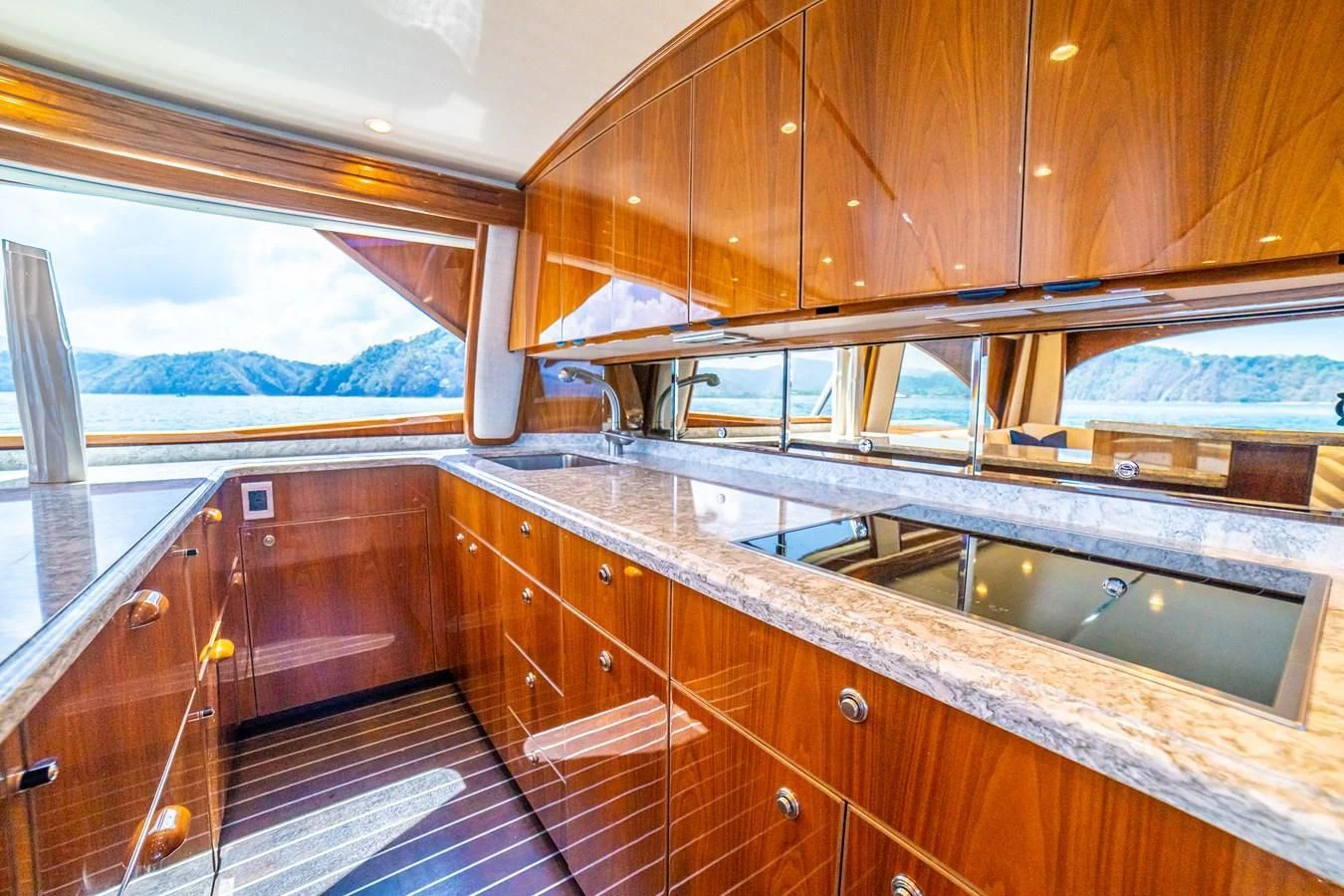 a kitchen with wooden cabinets aboard MANA Yacht for Sale