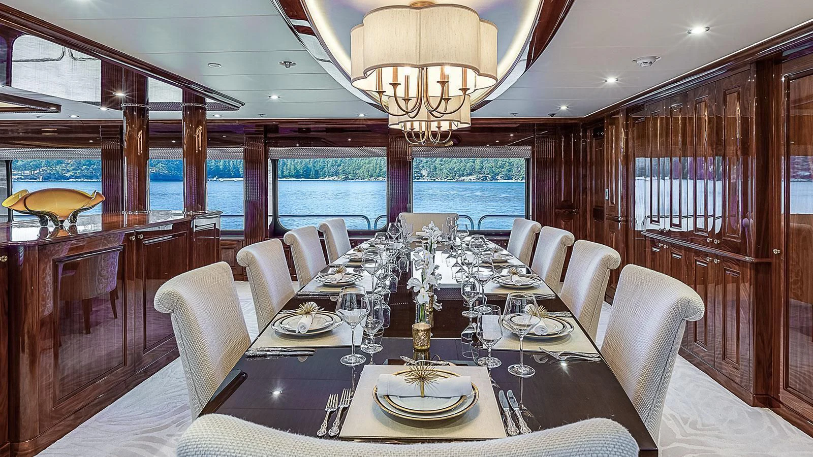 a dining room with a table set for a formal dinner aboard D'NATALIN IV Yacht for Sale