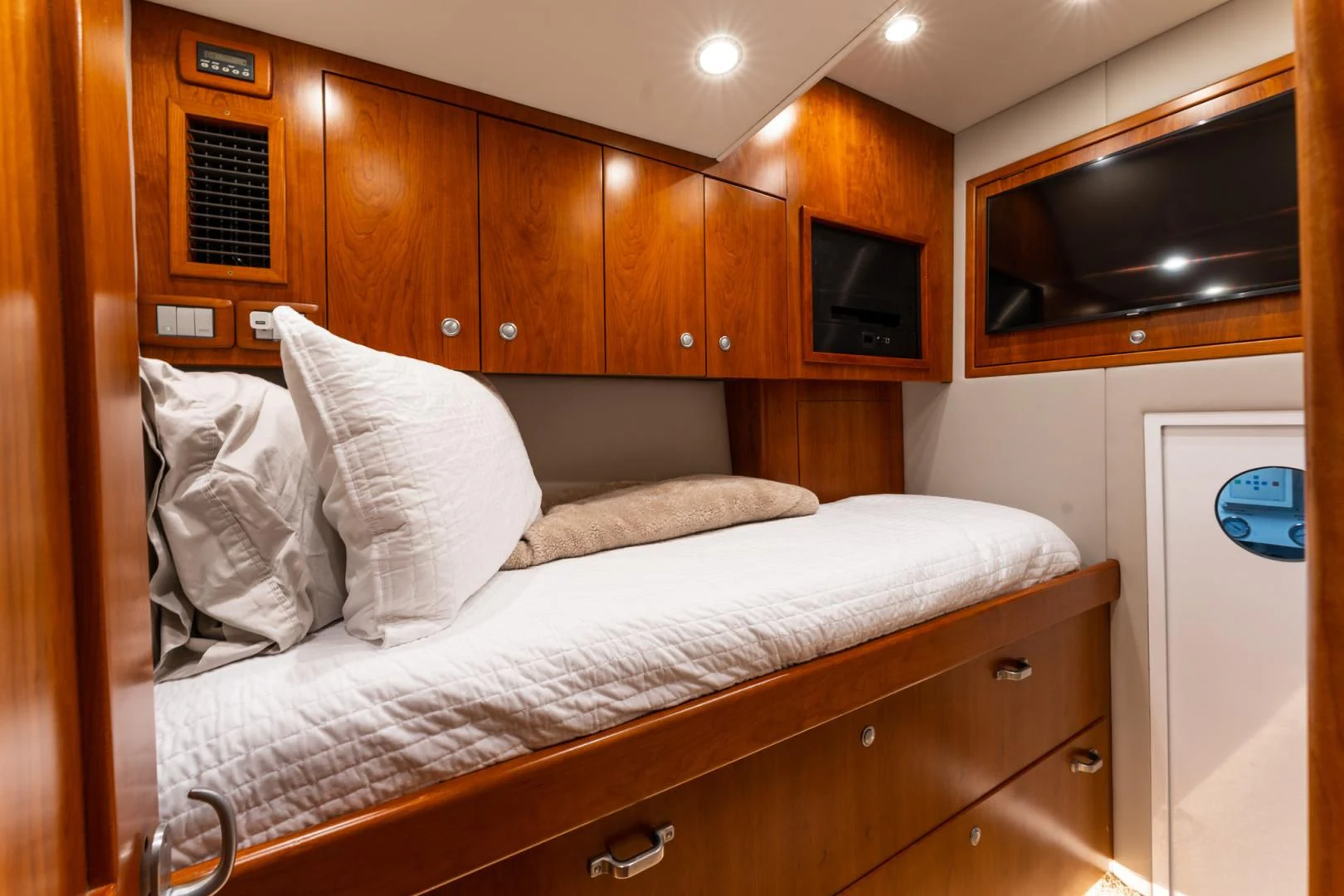 a bed with white sheets aboard LET  RIDE Yacht for Sale