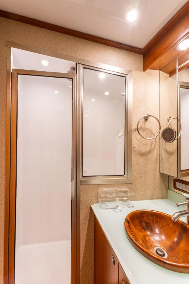 a bathroom with a sink and cabinets aboard LET  RIDE Yacht for Sale