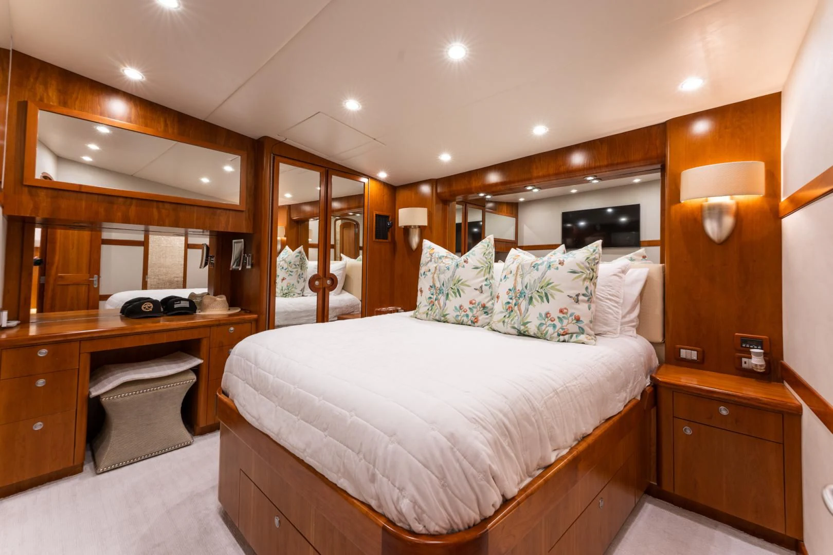 a bedroom with a bed and desk aboard LET  RIDE Yacht for Sale