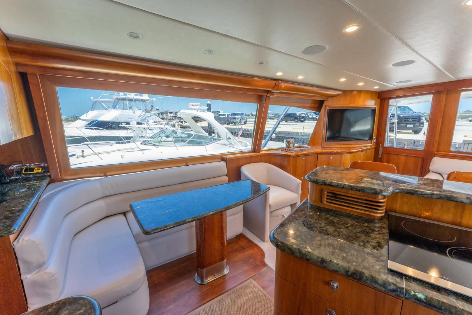 a room with a pool table and chairs aboard LET  RIDE Yacht for Sale