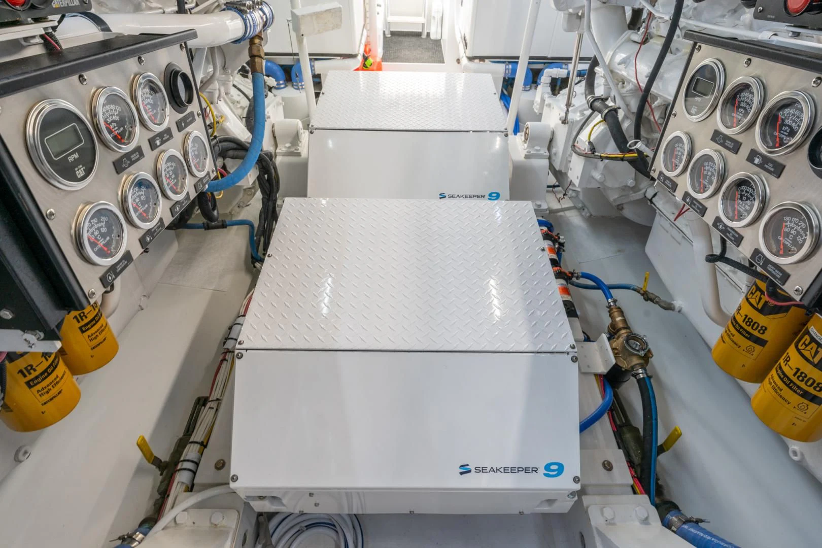 a white machine with a blue cable aboard LET  RIDE Yacht for Sale