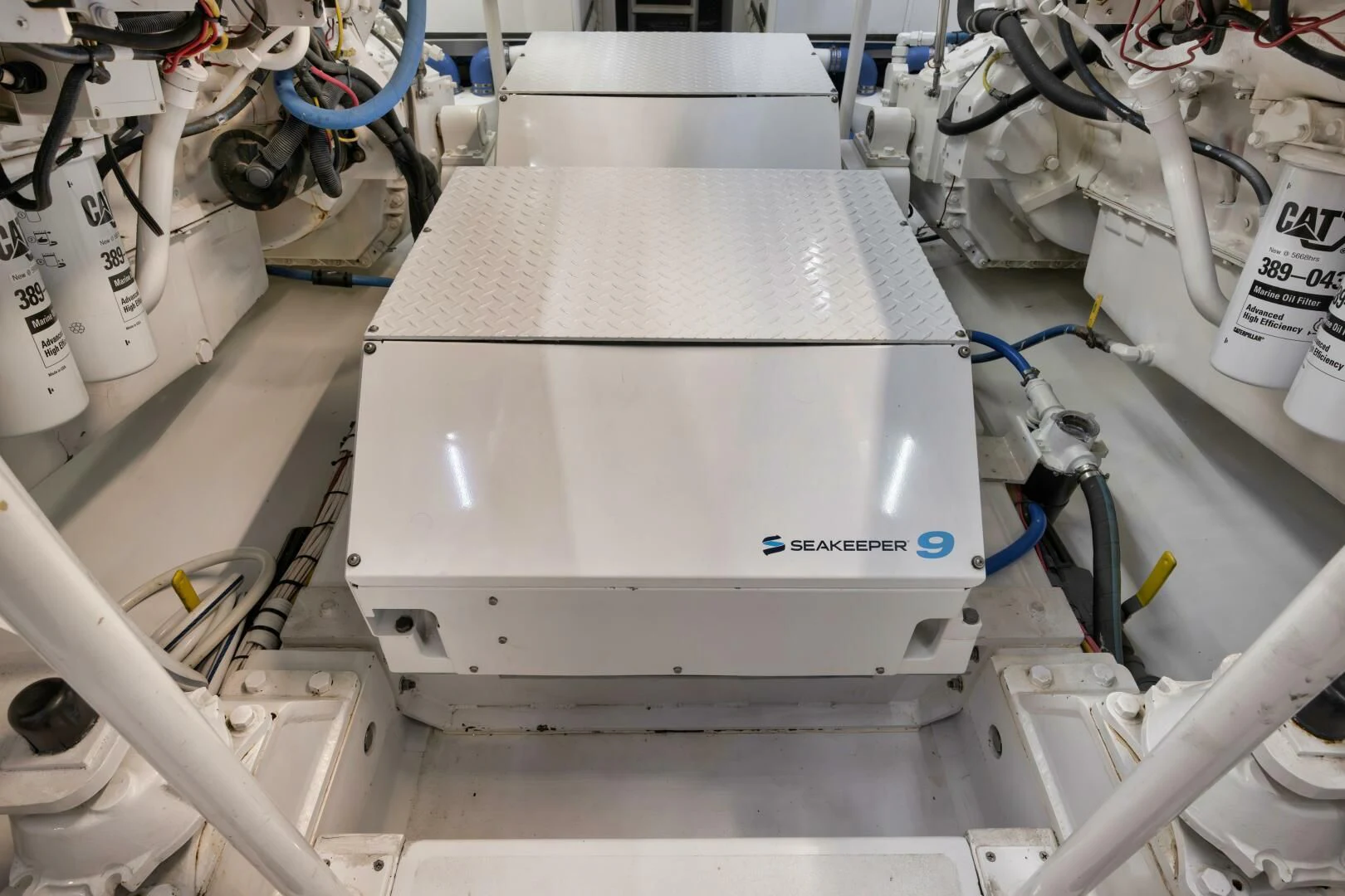 a white machine with a blue cable aboard LET  RIDE Yacht for Sale