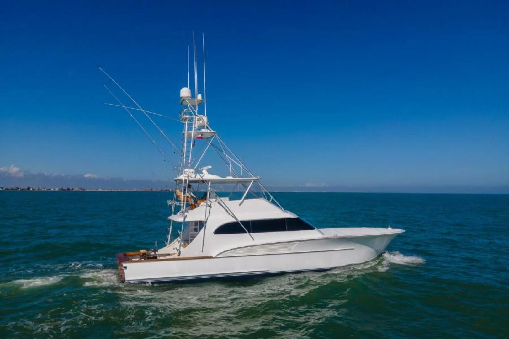 a white boat in the water aboard LET  RIDE Yacht for Sale