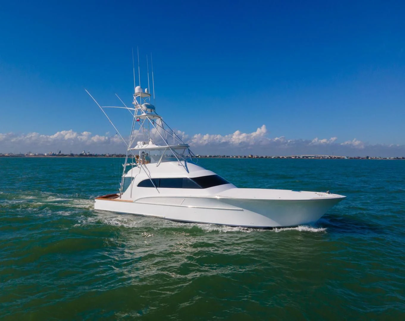 a white boat in the water aboard LET  RIDE Yacht for Sale