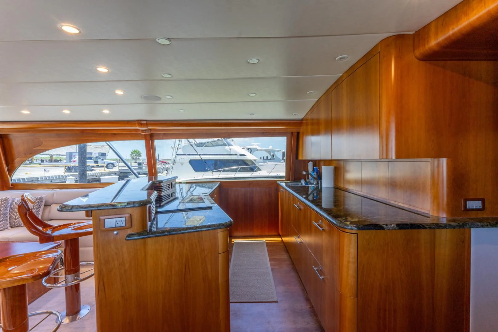 a kitchen with wooden cabinets aboard LET  RIDE Yacht for Sale