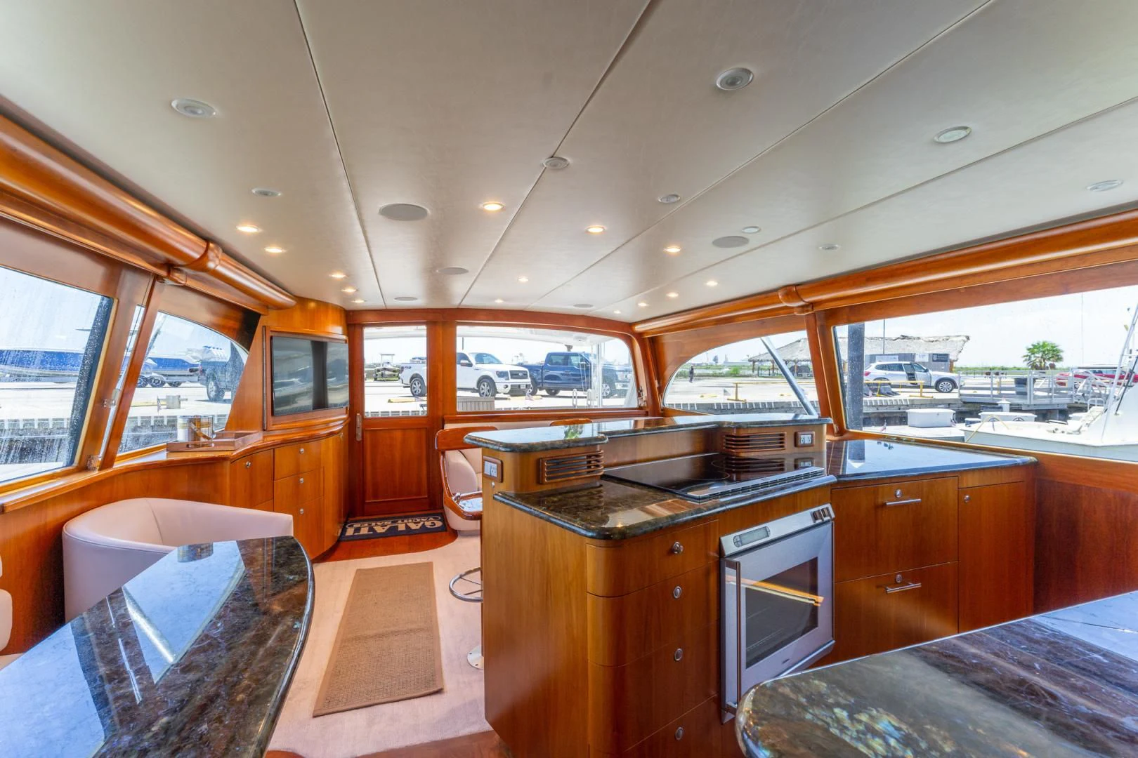 a kitchen with a large window aboard LET  RIDE Yacht for Sale