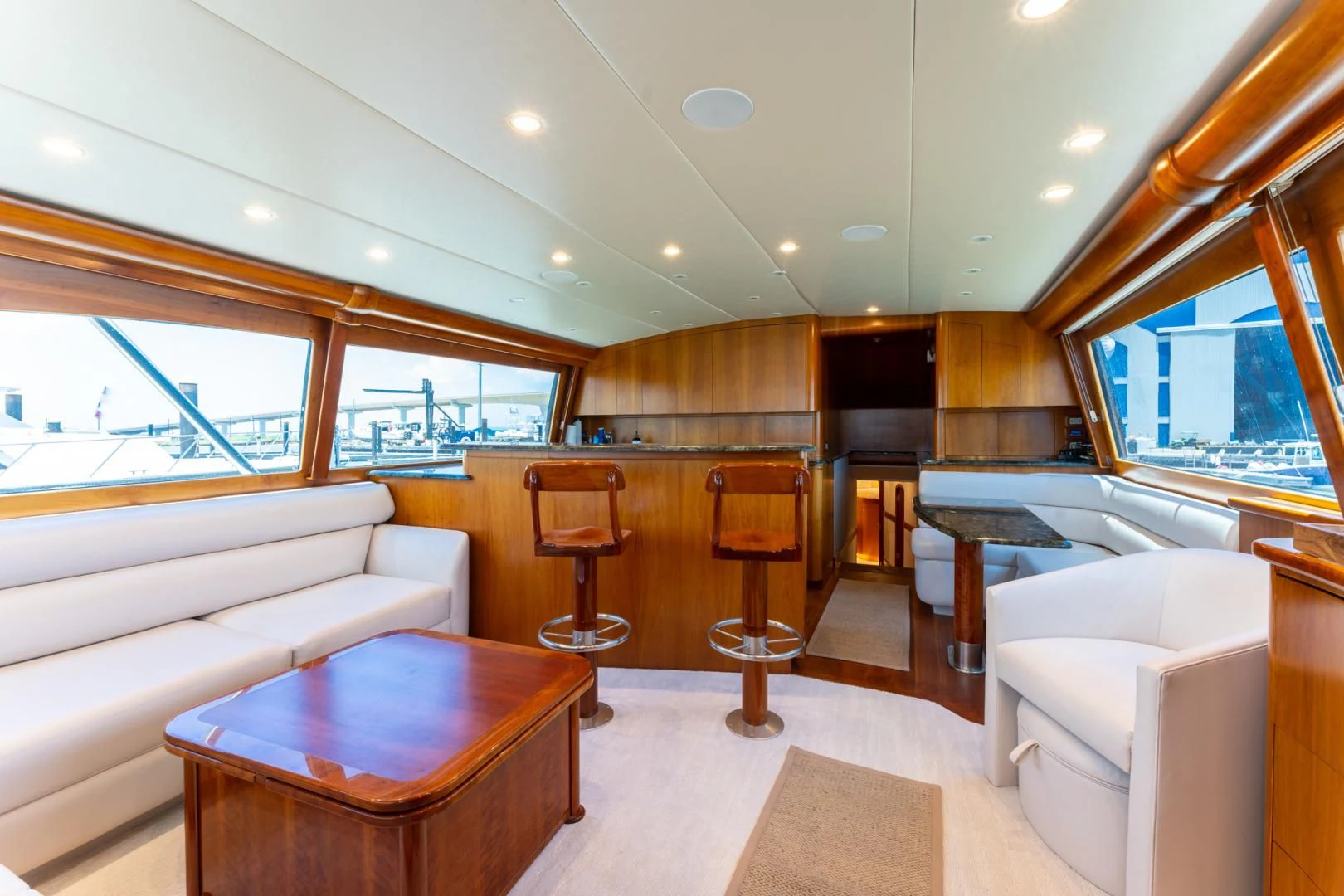 a living room with a large window aboard LET  RIDE Yacht for Sale