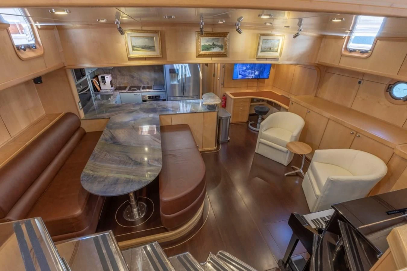 a room with a bar and chairs aboard DE VROUWE CHRISTINA Yacht for Sale