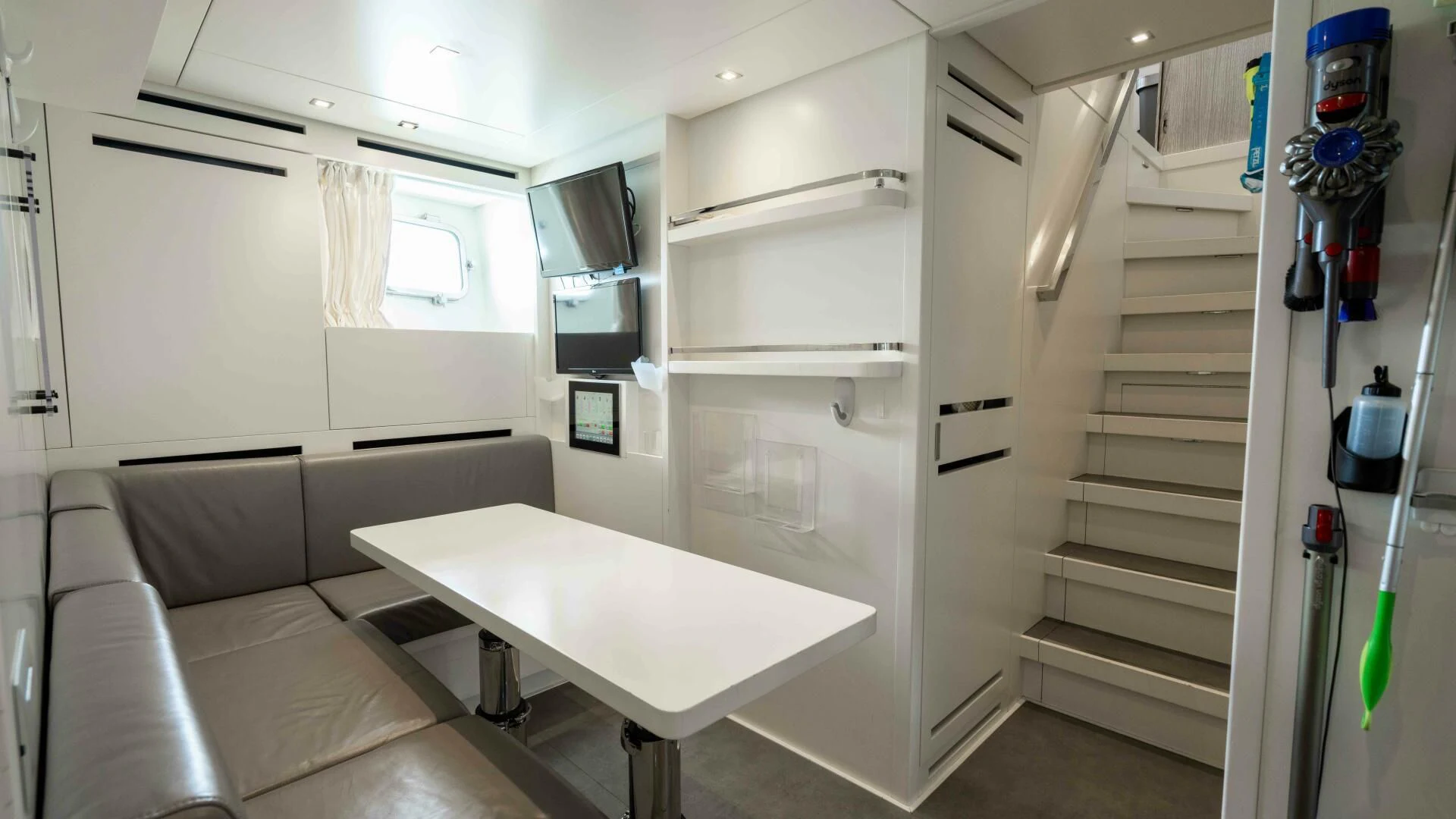 a room with a table and a couch aboard TIME OUT I Yacht for Sale