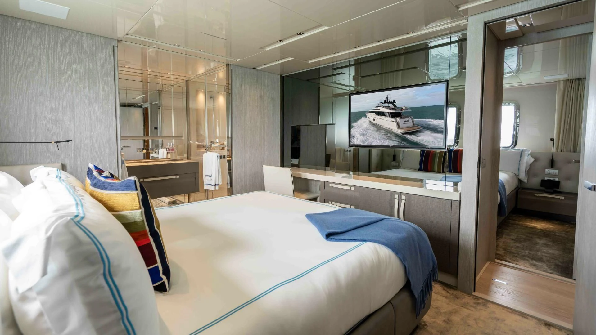 a room with a bed and a desk aboard TIME OUT I Yacht for Sale