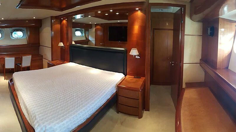 a room with a bed and a tv aboard BARON B Yacht for Sale