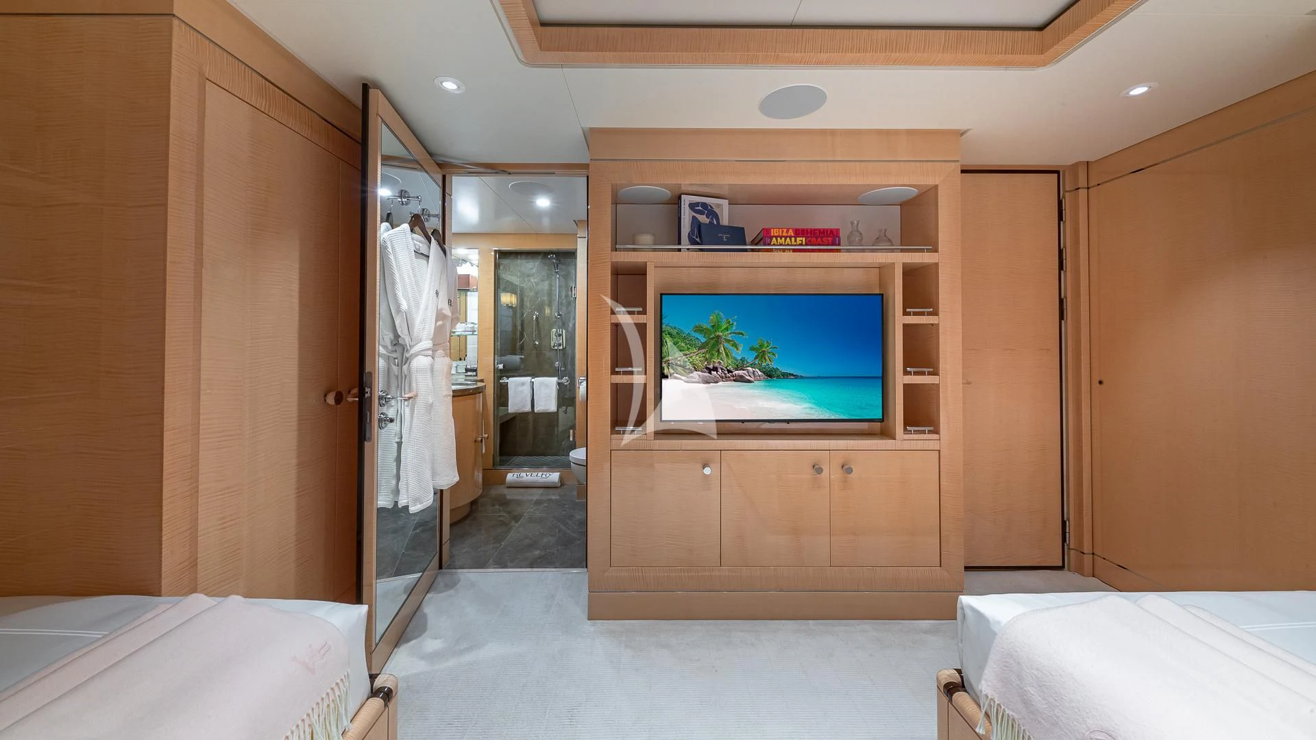a room with a tv and a bed aboard REVELRY Yacht for Sale