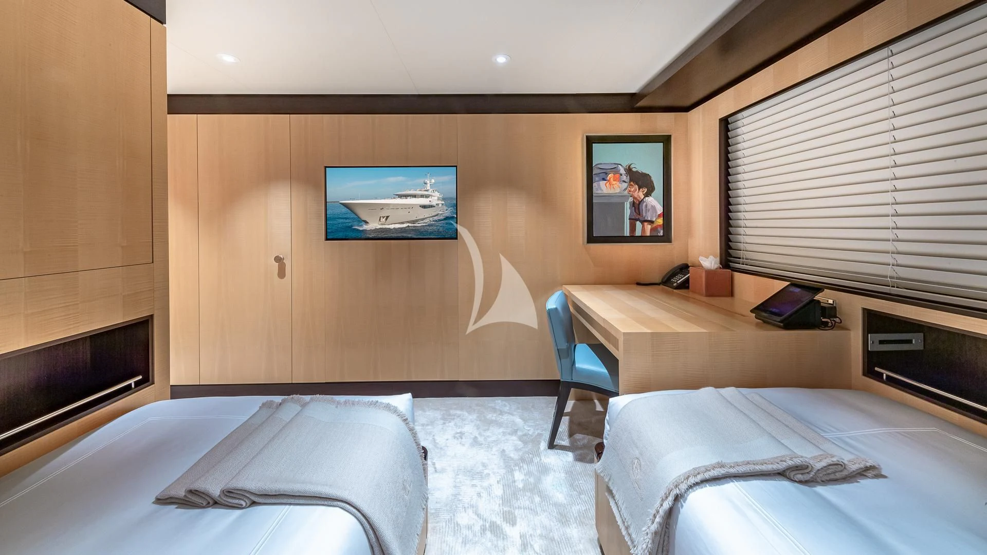a room with a bed and a desk aboard REVELRY Yacht for Sale