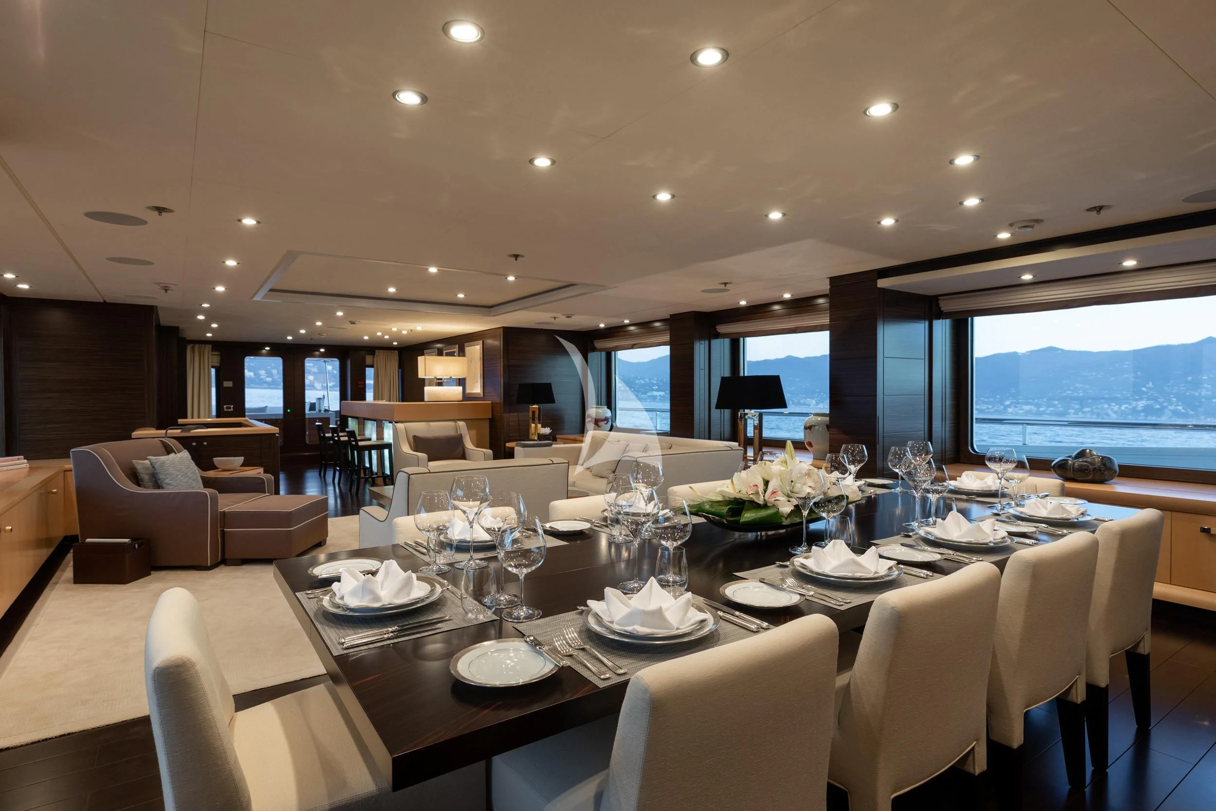 a large dining room with a large table and chairs aboard REVELRY Yacht for Sale