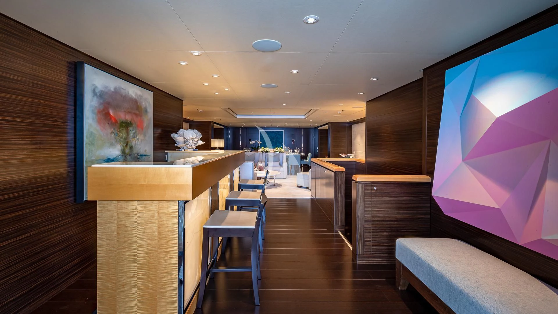 a room with a wood floor and a large screen with a large display aboard REVELRY Yacht for Sale