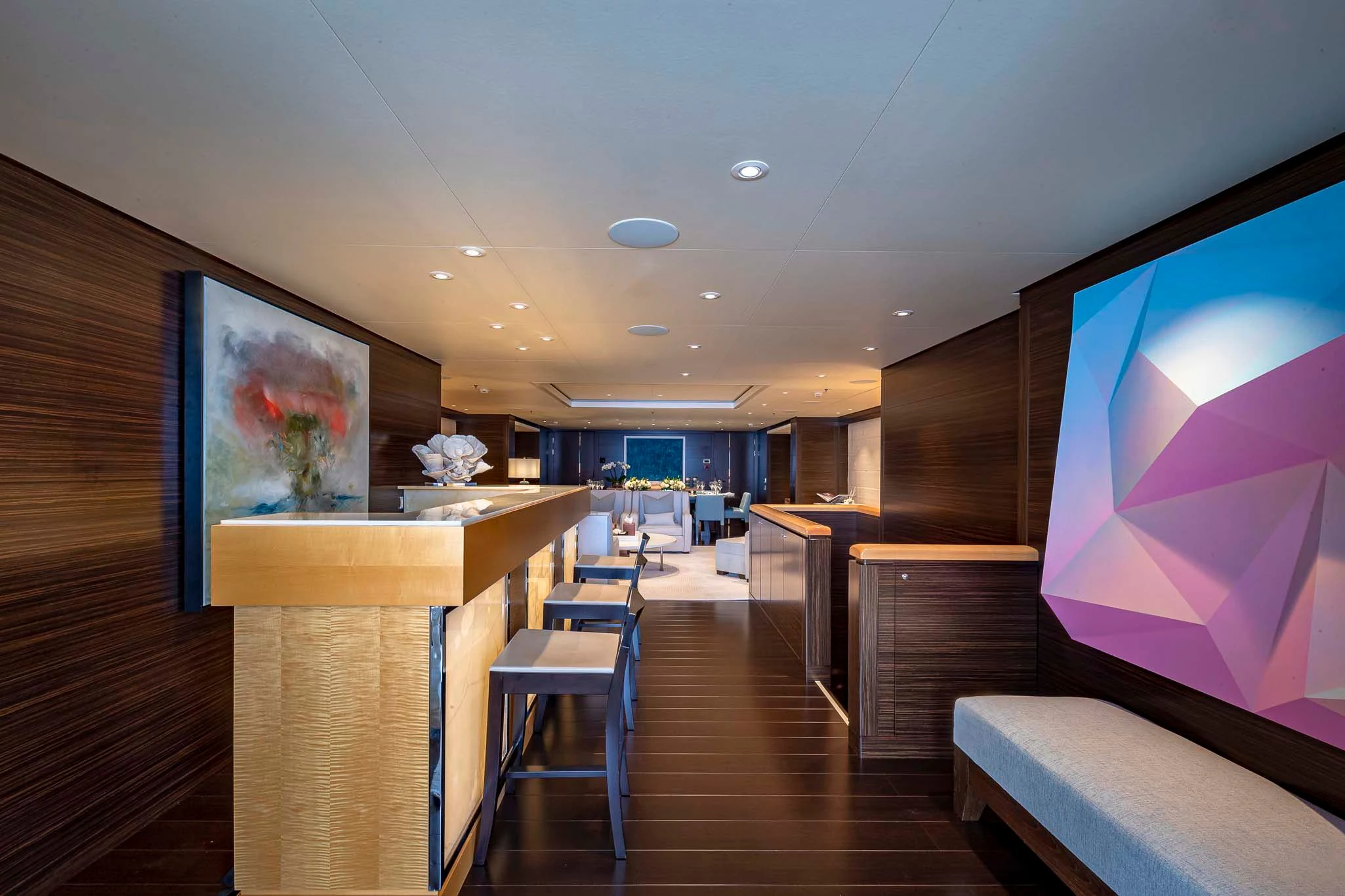a room with a wood floor and a large screen on the wall aboard REVELRY Yacht for Sale