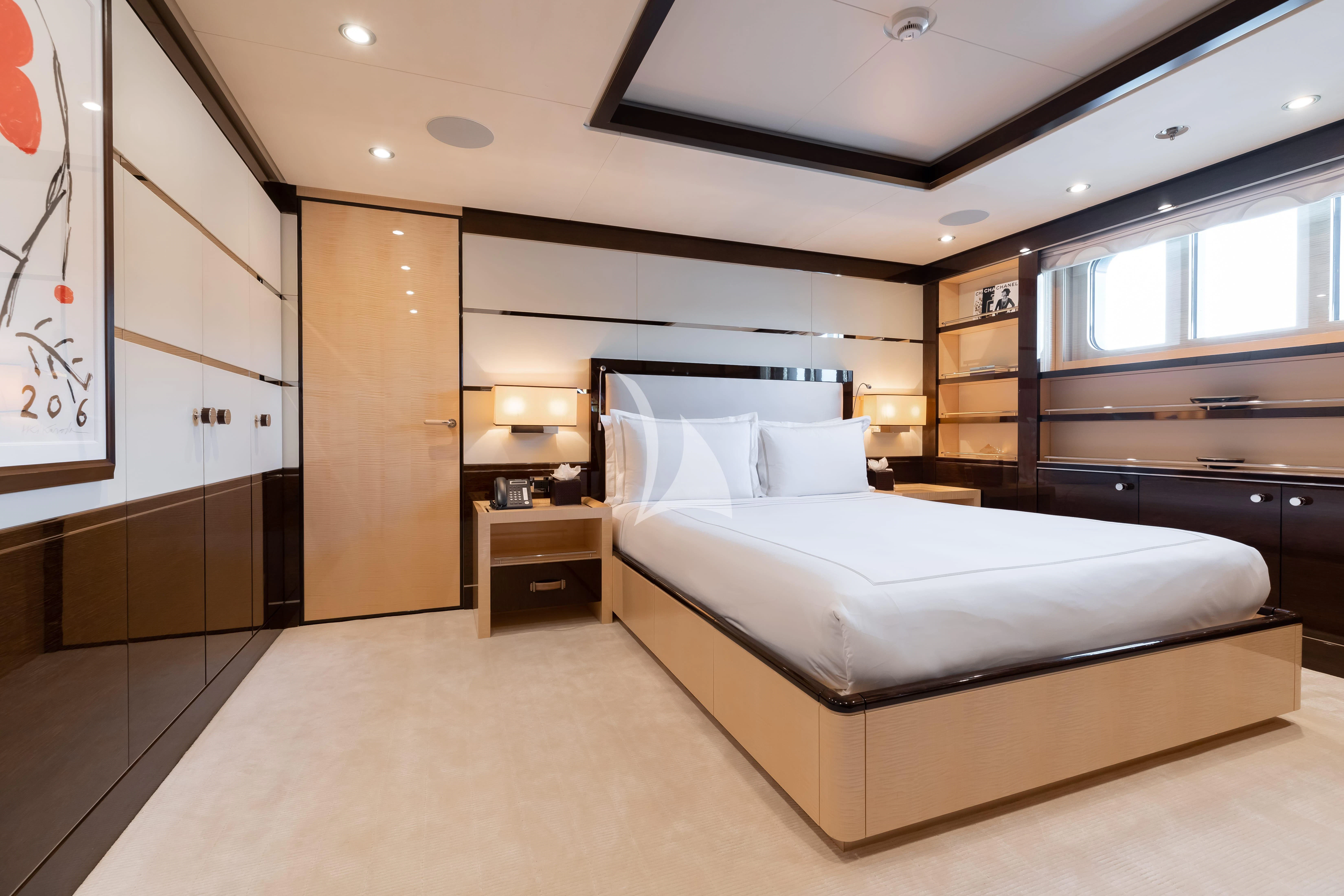 a room with a bed and a desk aboard REVELRY Yacht for Sale