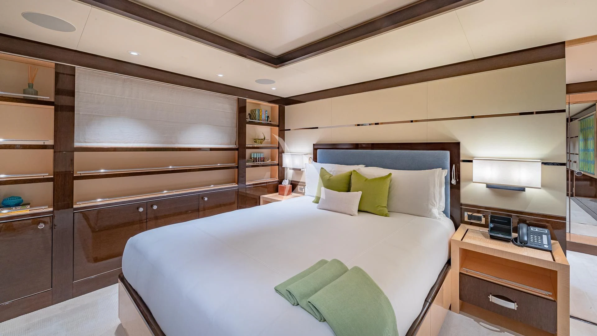 a bedroom with a bed and a desk aboard REVELRY Yacht for Sale