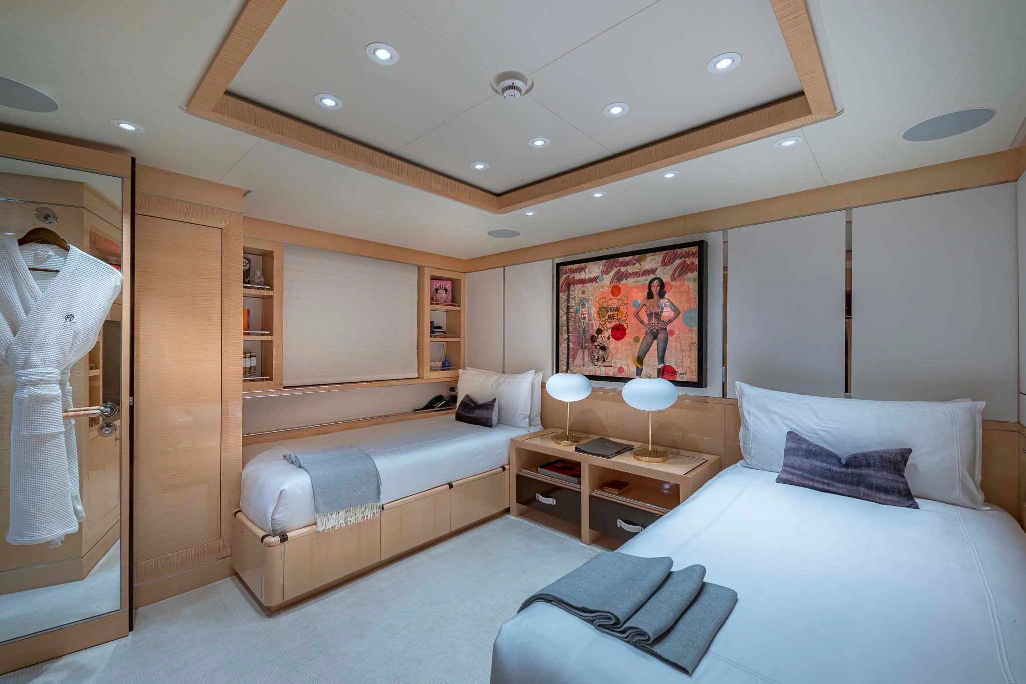 a bedroom with a bed and a desk aboard REVELRY Yacht for Sale
