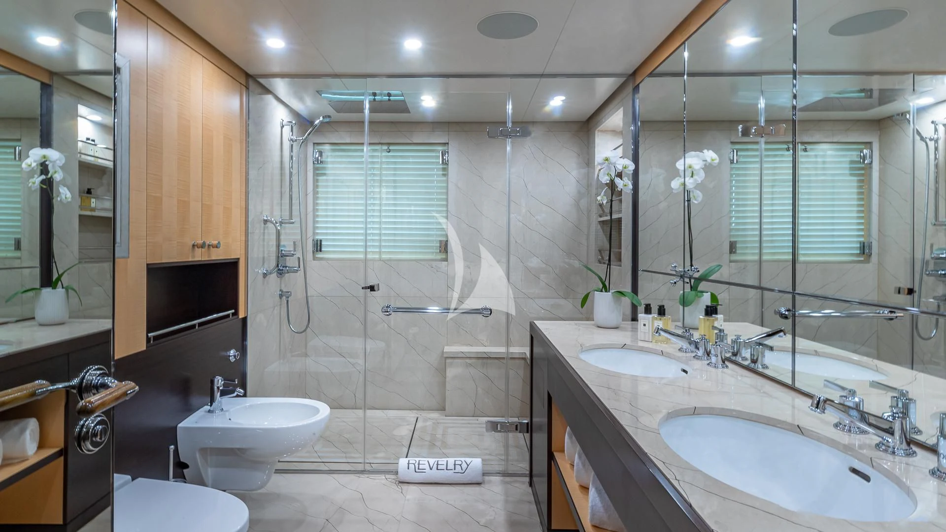 a bathroom with a glass shower aboard REVELRY Yacht for Sale
