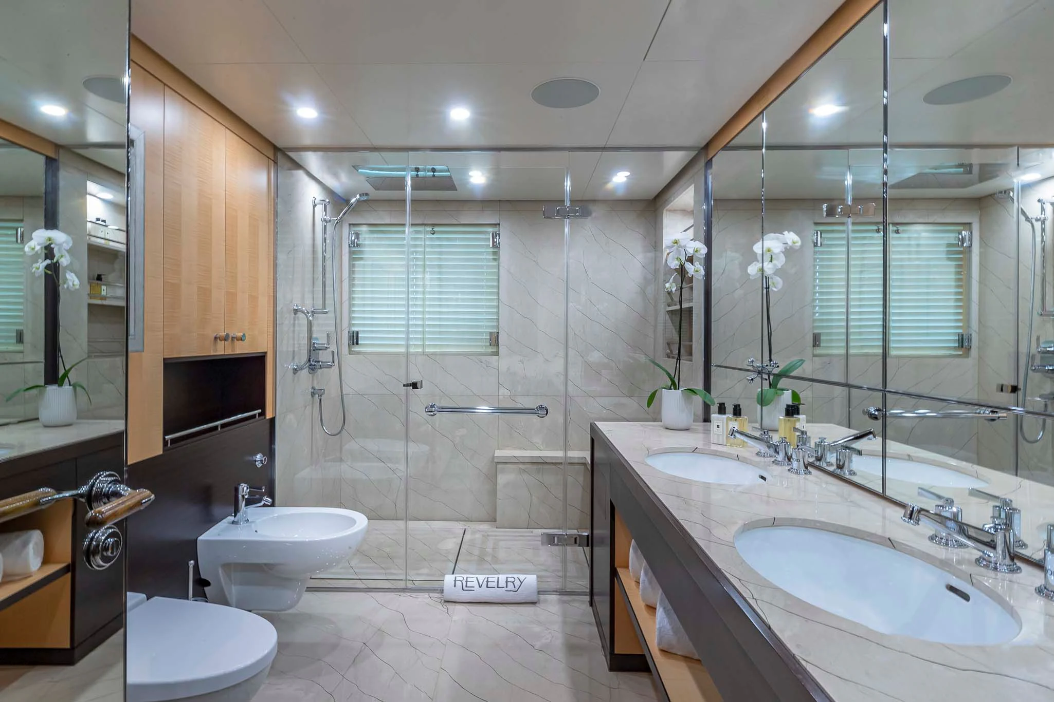a bathroom with a large glass shower aboard REVELRY Yacht for Sale