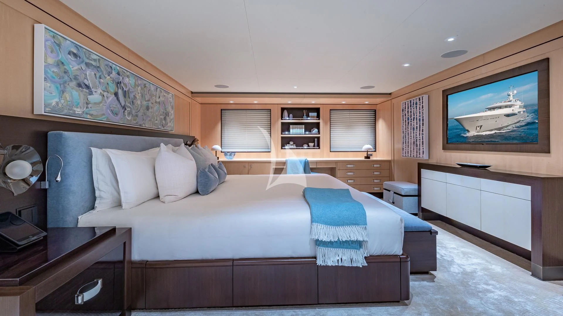 a bedroom with a bed and a desk aboard REVELRY Yacht for Sale