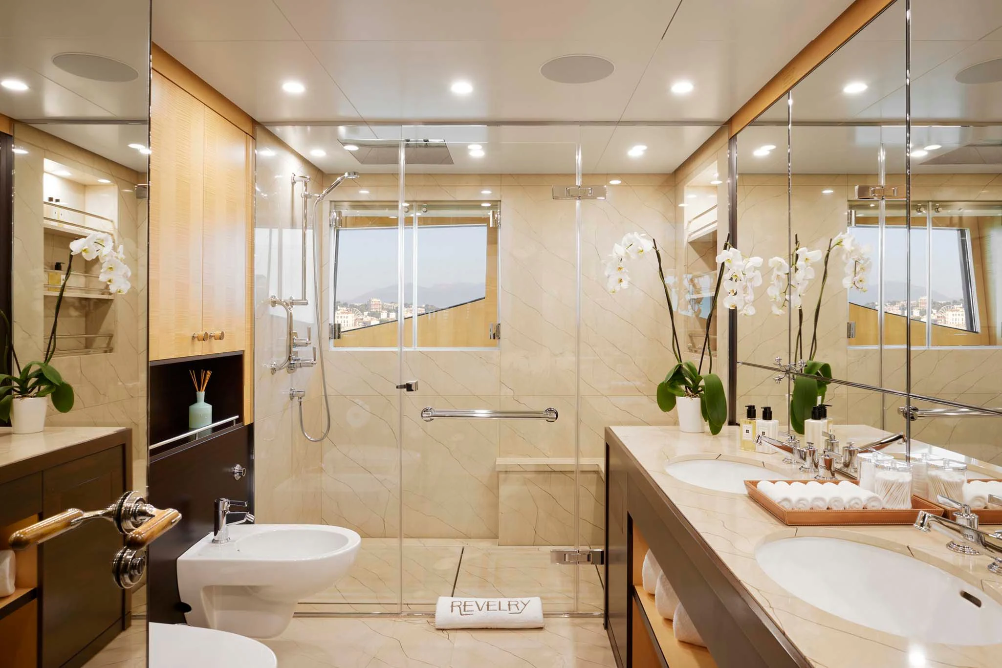 a bathroom with a large mirror aboard REVELRY Yacht for Sale