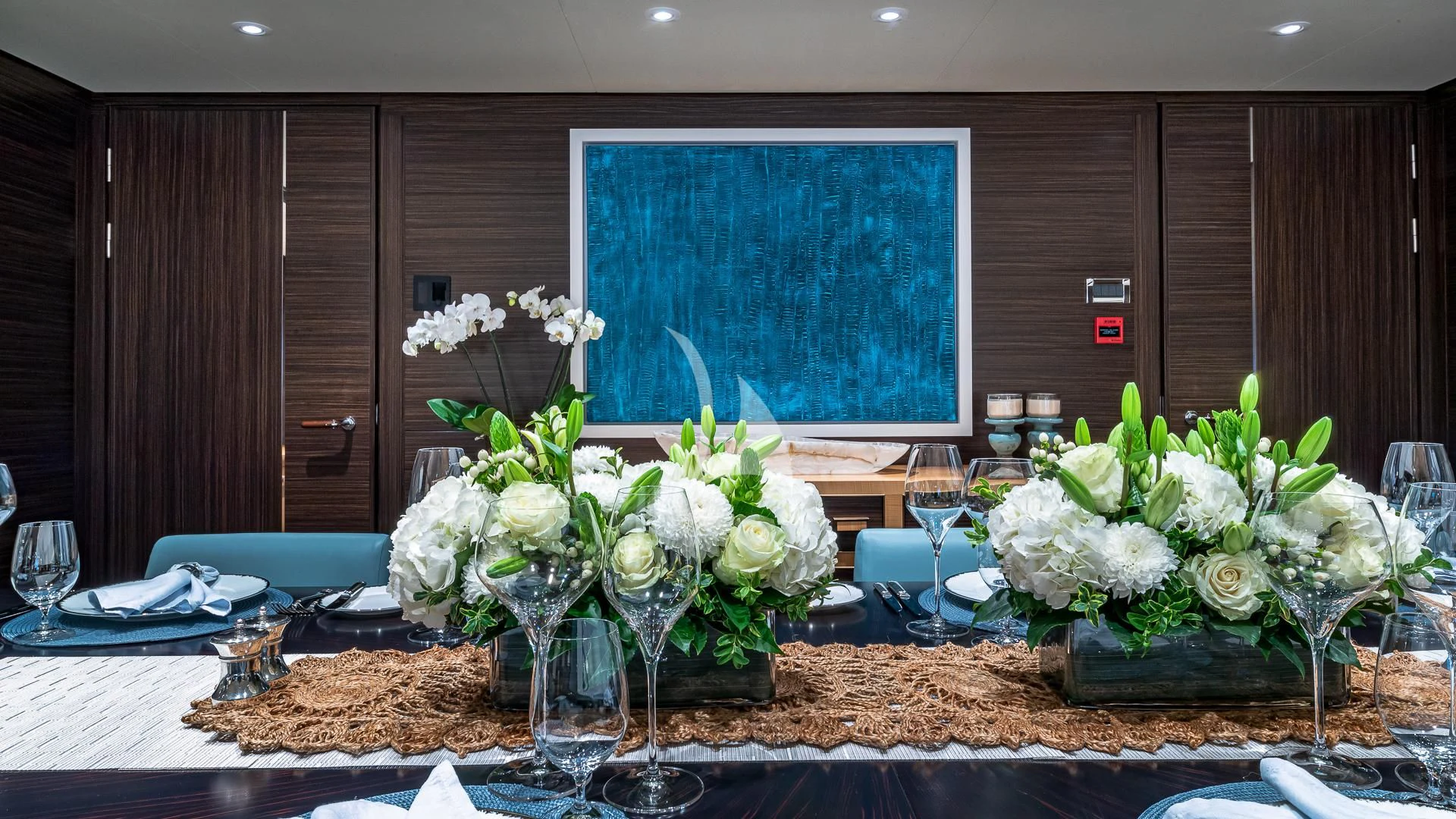 a table with flowers and glasses aboard REVELRY Yacht for Sale