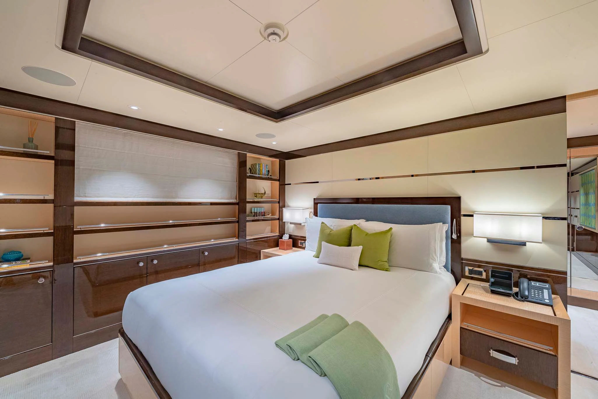 a bedroom with a bed and a desk aboard REVELRY Yacht for Sale