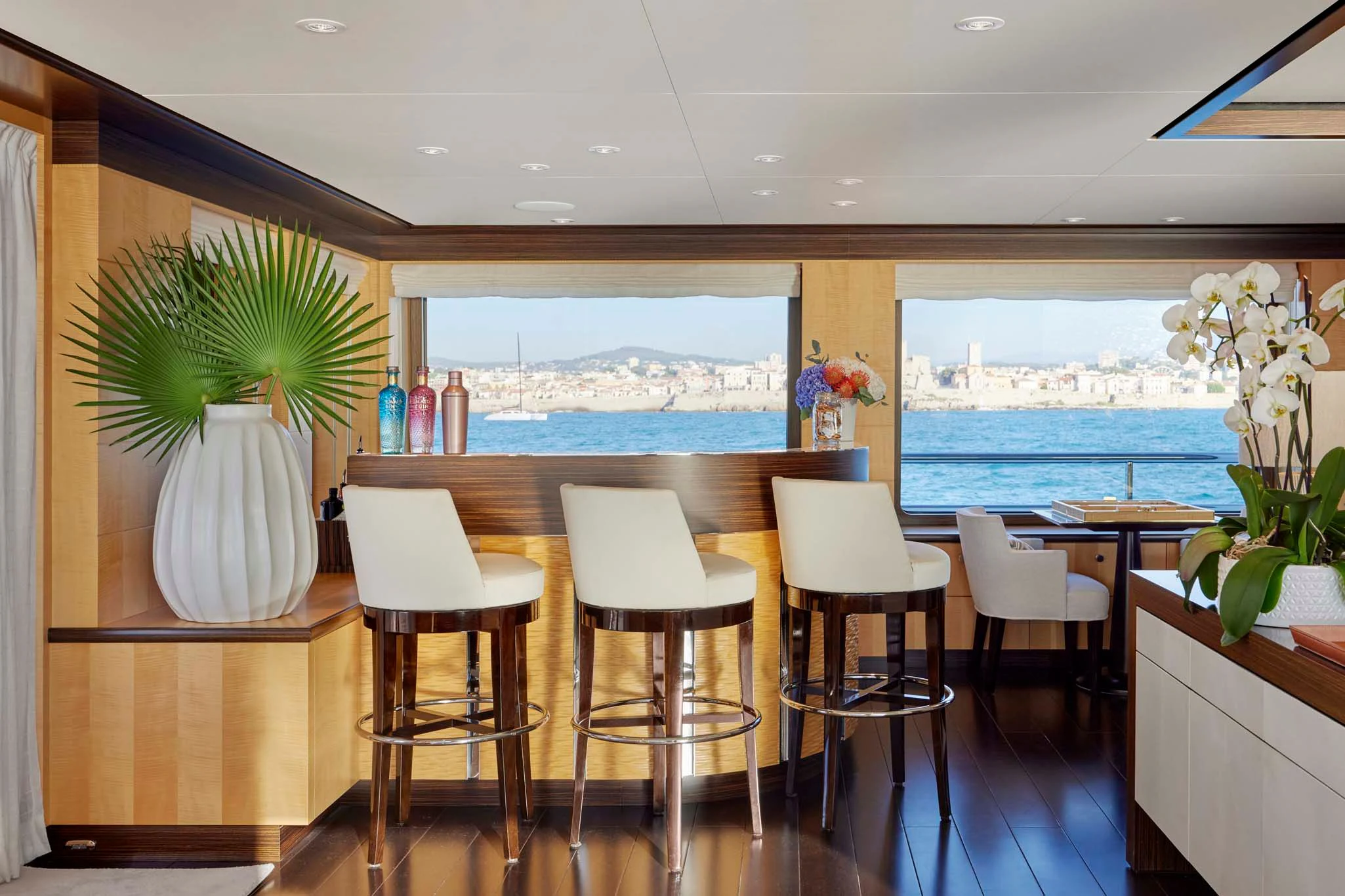 a room with tables and chairs aboard REVELRY Yacht for Sale