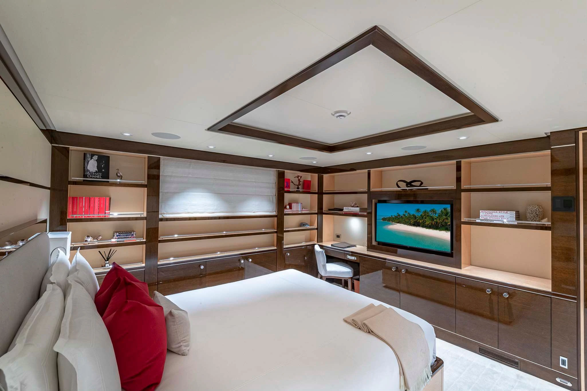a bedroom with a tv and a bed aboard REVELRY Yacht for Sale