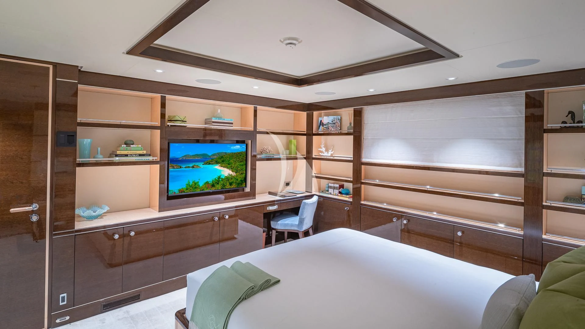 a room with a tv and a bed aboard REVELRY Yacht for Sale