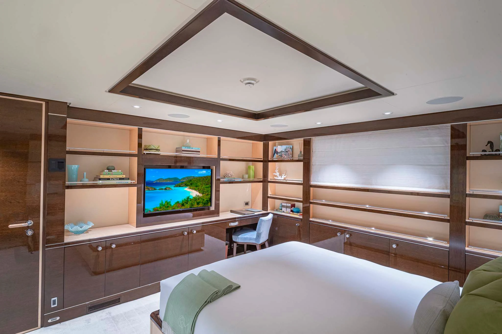 a room with a tv and a bed aboard REVELRY Yacht for Sale