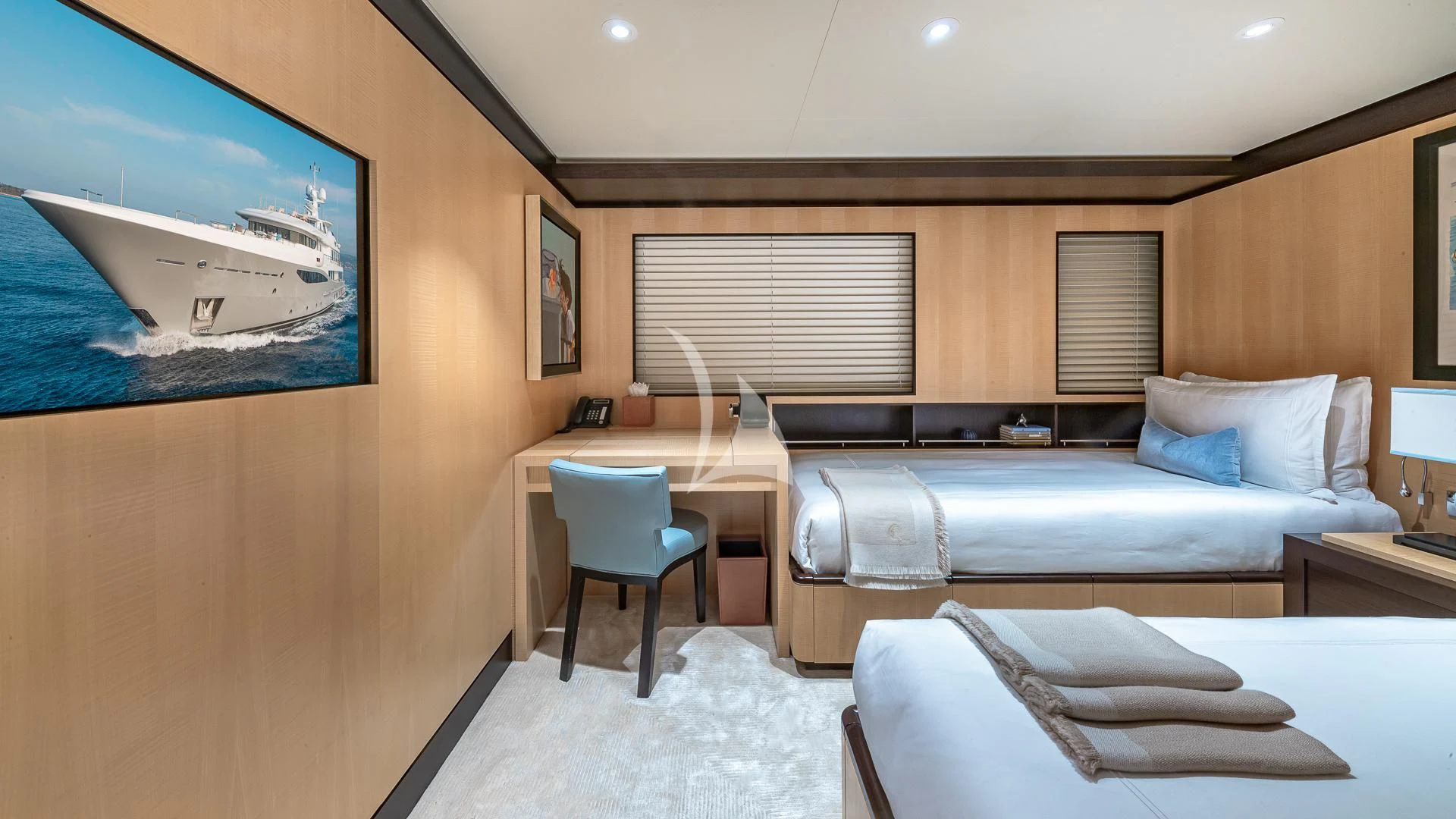 a room with a bed and a desk aboard REVELRY Yacht for Sale
