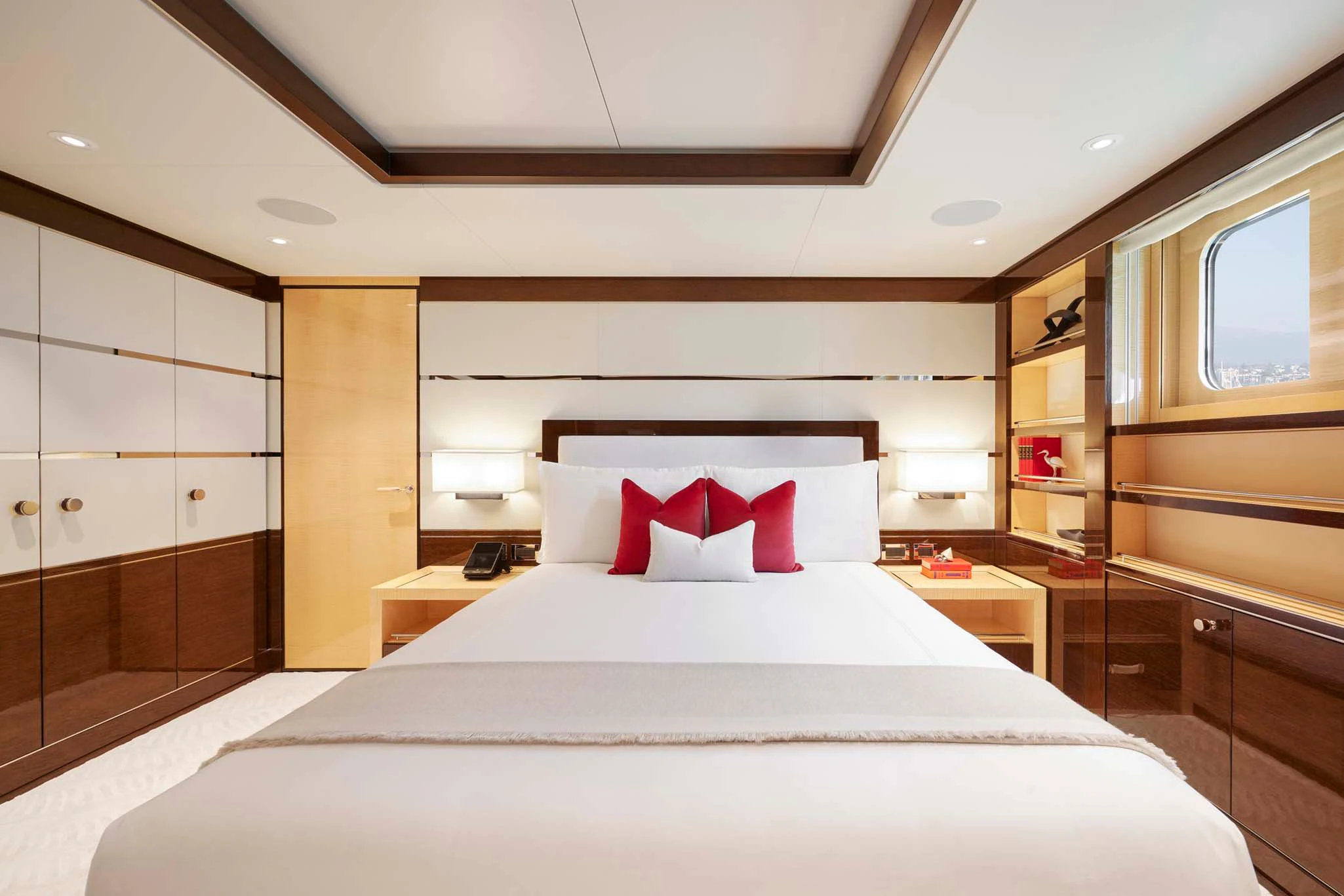 a bedroom with a bed and a mirror aboard REVELRY Yacht for Sale