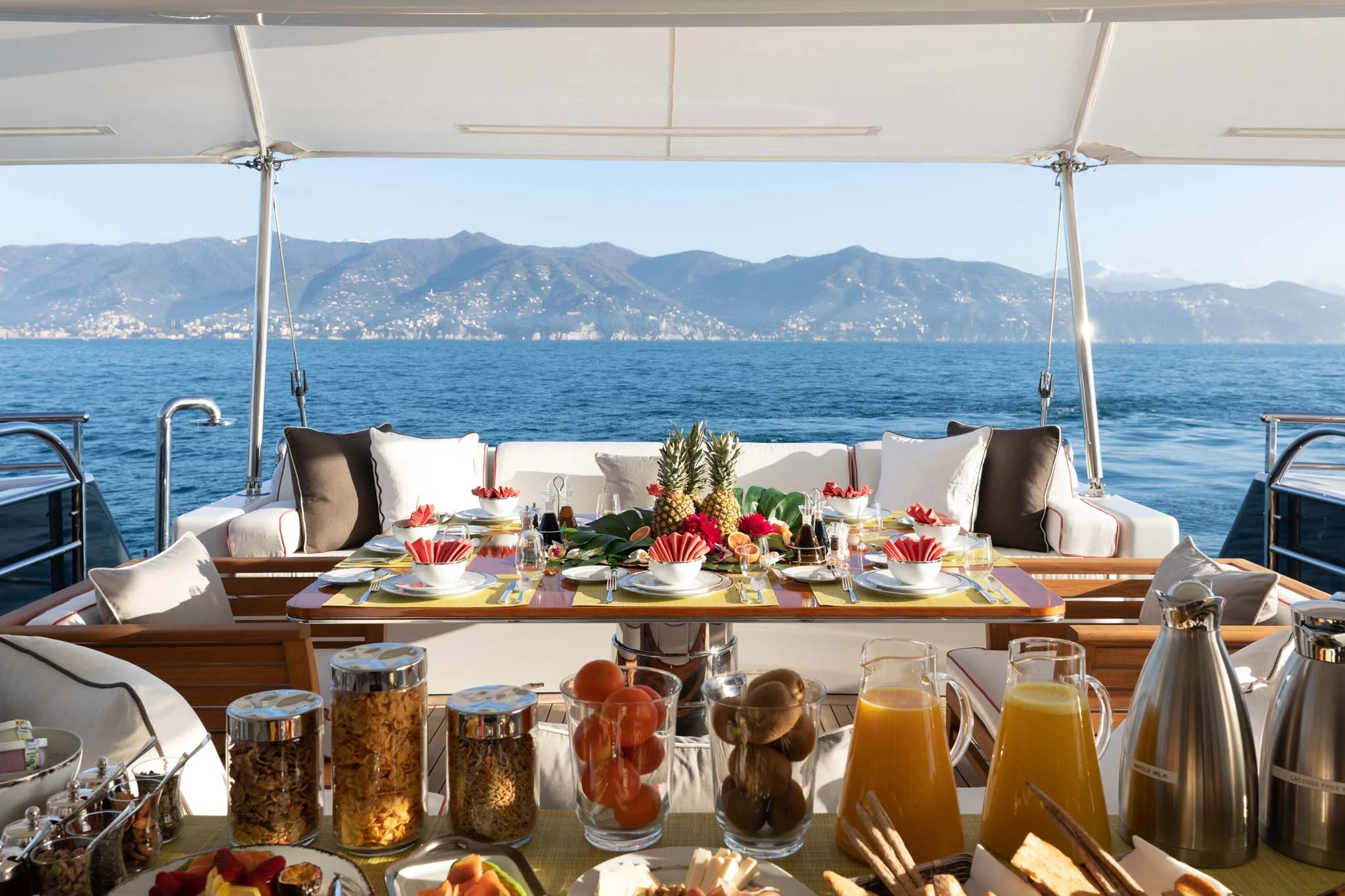 a table with food and drinks on it aboard REVELRY Yacht for Sale