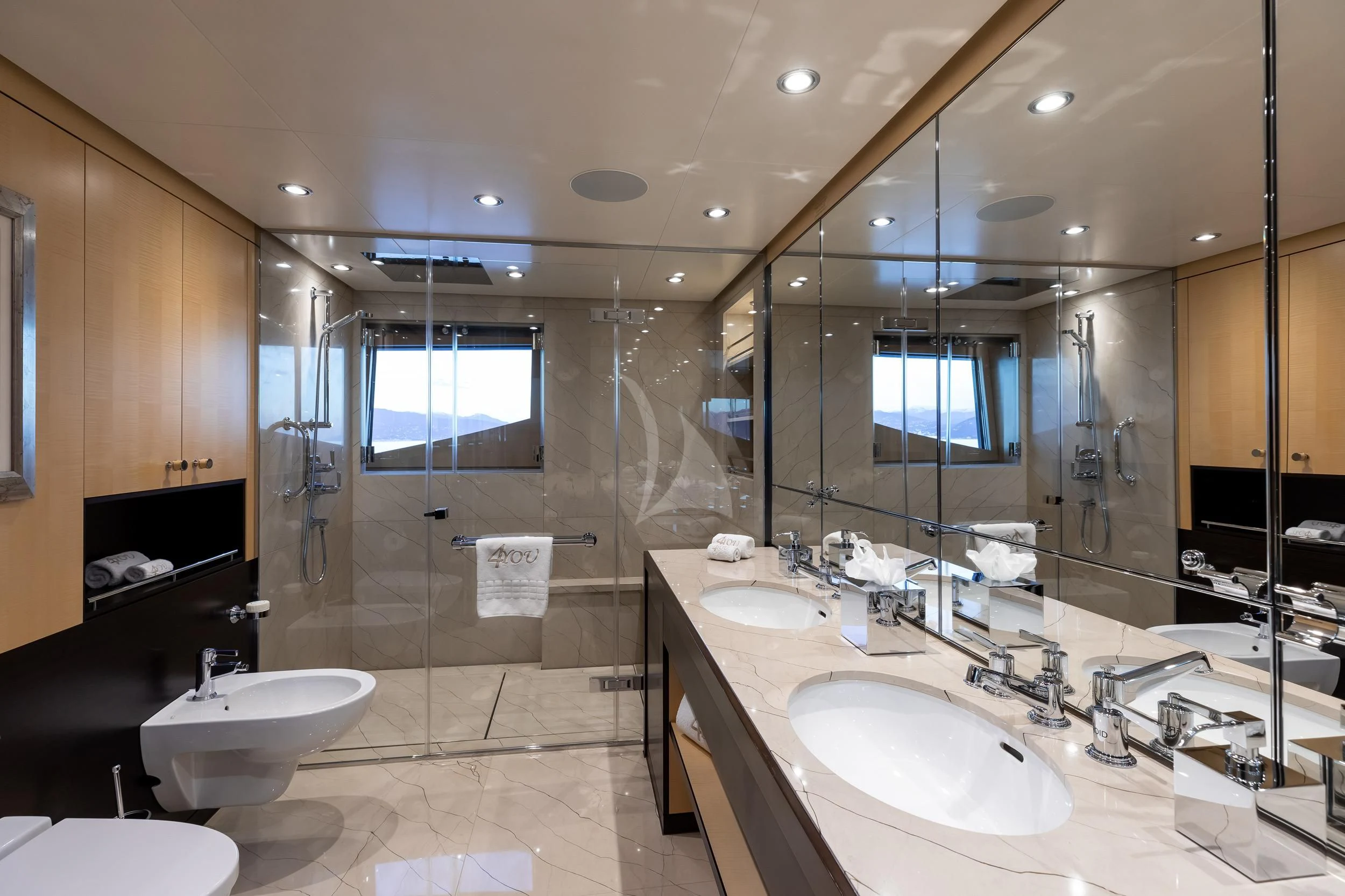 a bathroom with two sinks and a large mirror aboard REVELRY Yacht for Sale
