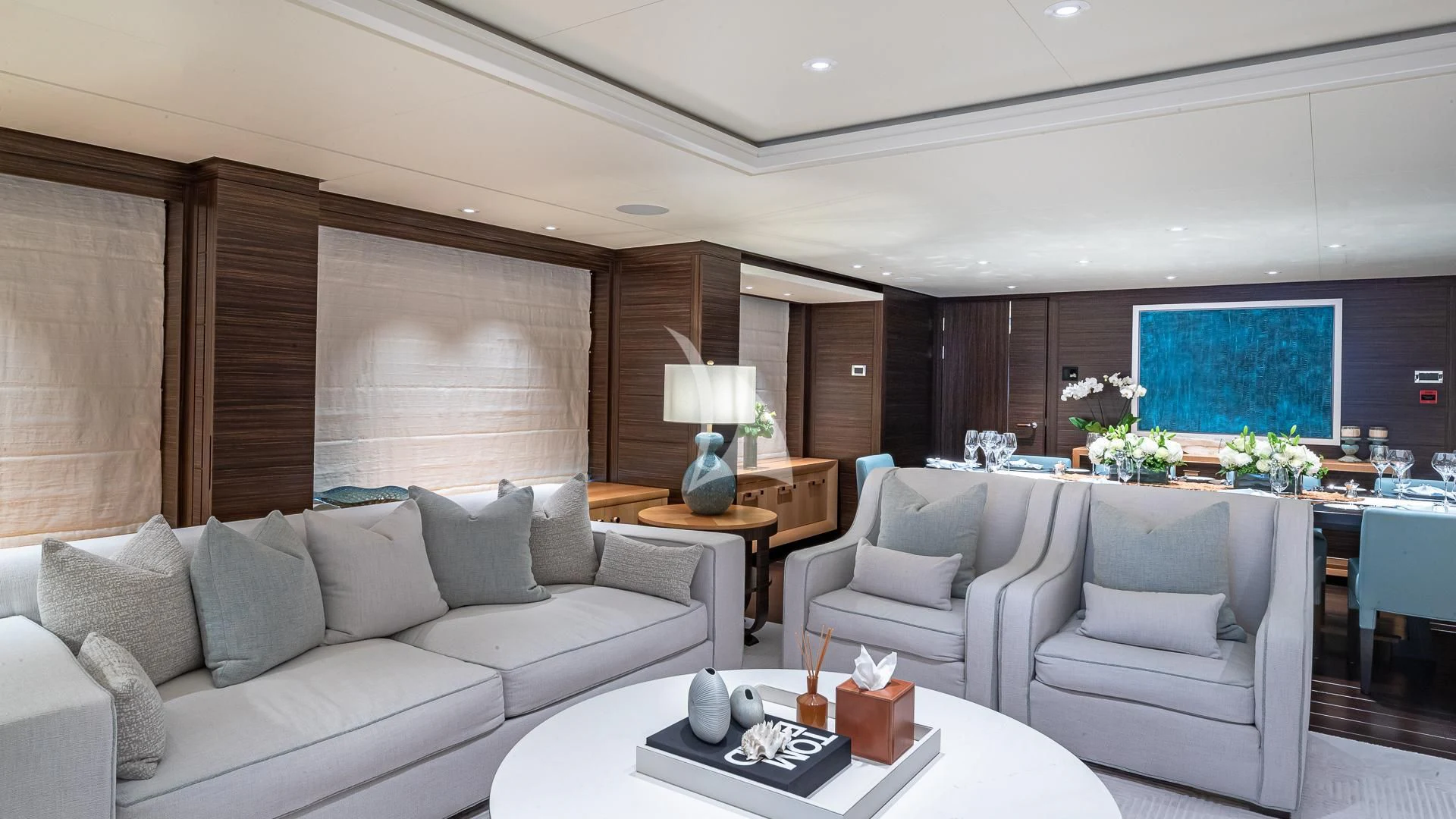 a living room with white couches aboard REVELRY Yacht for Sale