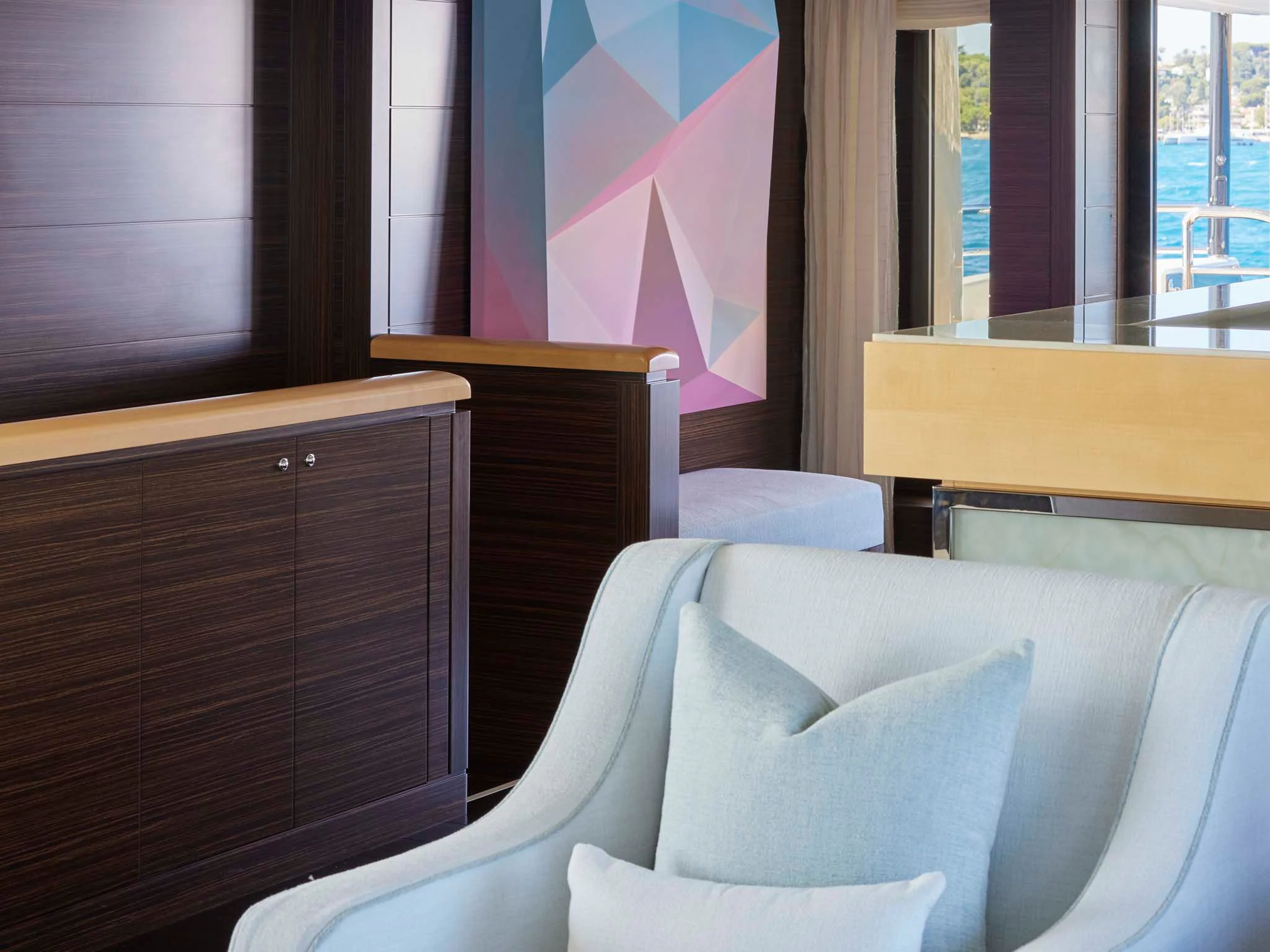 a room with a couch and a window aboard REVELRY Yacht for Sale